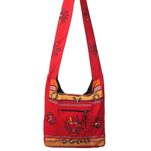 May include: Red canvas shoulder bag with a zippered pocket and embroidered sun and flower designs.