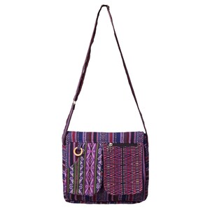 May include: Purple and red patterned shoulder bag with a zippered pocket and a wooden ring detail.