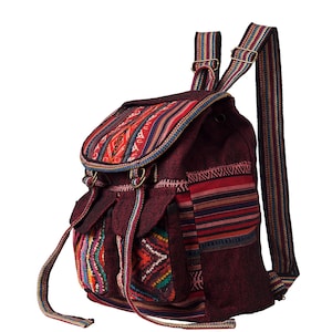 May include: A burgundy canvas backpack with colourful woven fabric accents. The backpack has a drawstring closure and two adjustable straps.