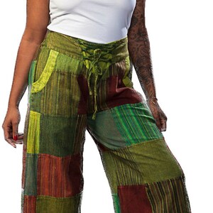 May include: Green, brown, and red patchwork pants with a lace-up detail at the waist.