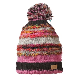 Peut inclure: Un bonnet tricoté coloré avec un pompon. Le chapeau présente un mélange de fils roses, gris, noirs et oranges. Le bord est noir et une petite étiquette marron avec le mot "ark" est cousue sur le côté. Le pompon est un mélange de rose, noir et gris.