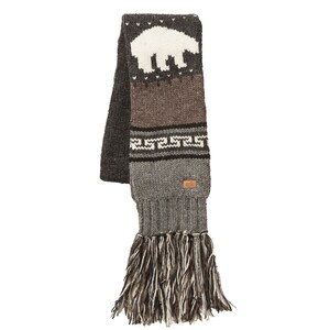 May include: A grey, brown, and white knitted scarf with a polar bear design. The scarf has a geometric pattern and fringe at the bottom. The label reads "ark".
