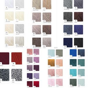 May include: A color chart displaying various yarn colors, including white, cream, gray, brown, blue, and pink. Each color is labeled with a number and a descriptive name, such as "Ivory" and "Royal Blue."
