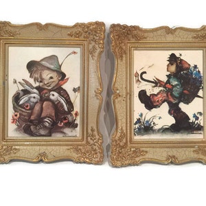 May include: Two framed vintage illustrations of children in a whimsical style. The first image shows a boy holding two white rabbits in a basket. The second image shows a boy walking with an umbrella and a backpack.