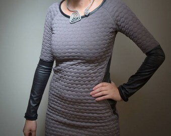 Quilted women's winter dress and imitation leather in purple color.