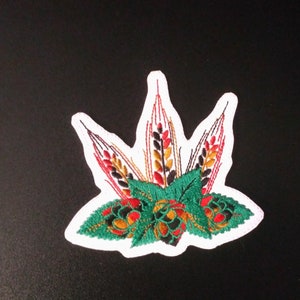 May include: Embroidered patch with a green, red, and yellow wheat design. The wheat is surrounded by green leaves and brown and red hops.