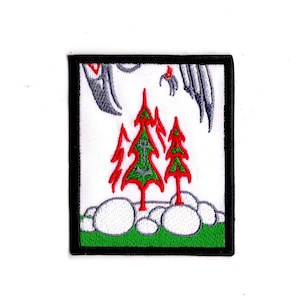 May include: A white embroidered patch with a green border. The patch features a red and green stylized tree with a silver anchor in the center. The tree is surrounded by white rocks and a green grassy area. The top of the patch features a gray stylized bird.