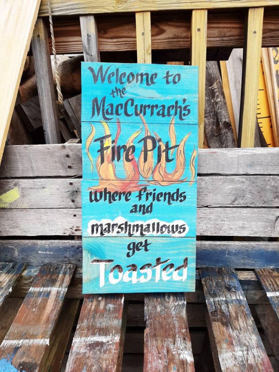to Our Fire Pit Where Friends and Marchmellows Get Toasted Sign