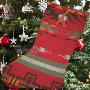 May include: Red and green Christmas stocking with a southwestern pattern and a silver button with a brown leather strap.