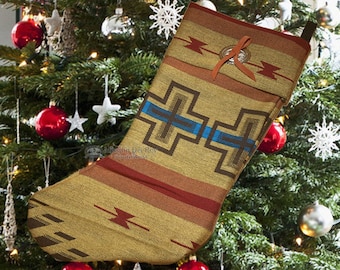 May include: A brown and tan Christmas stocking with a geometric pattern in blue, brown, and red. The stocking has a brown leather loop and a silver button.