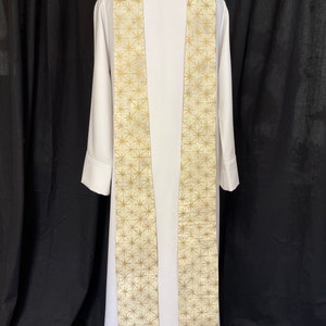 May include: White liturgical stole with a gold star pattern.