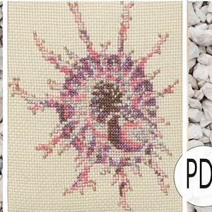May include: Cross stitch pattern of a pink and purple flower with a brown center. The pattern is on a beige background and is surrounded by a white border. The pattern is labeled "PDF" in the bottom right corner.