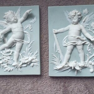 Pair of putti biscuit plates 19th century Vierzon
