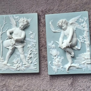 PAIR OF BISCUIT PLATES 19th century putti Volkstedt porcelain