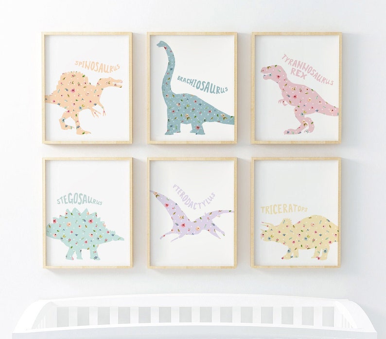 May include: Six framed art prints featuring dinosaur silhouettes filled with floral patterns. The dinosaurs include Spinosaurus, Brachiosaurus, Tyrannosaurus Rex, Stegosaurus, Pterodactylus, and Triceratops. Each print has a white background and a light wood frame.