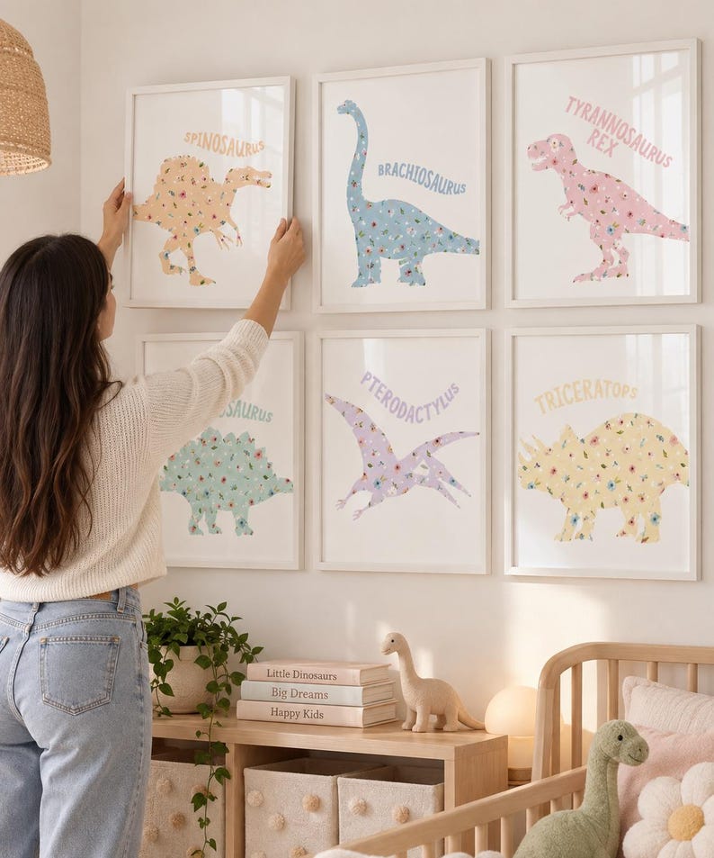 May include: Six framed wall art prints featuring floral-patterned dinosaurs including a Spinosaurus, Brachiosaurus, Tyrannosaurus Rex, Stegosaurus, Pterodactylus, and Triceratops, each labeled with its name in a soft-colored, sans-serif font.
