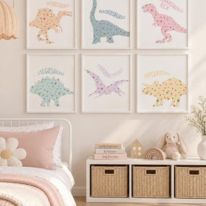 May include: Six framed wall art prints featuring floral-patterned dinosaurs in pastel colors. The prints display a Spinosaurus, Brachiosaurus, Tyrannosaurus Rex, Stegosaurus, Pterodactylus, and Triceratops, each with its name printed above the illustration.
