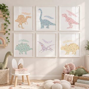 May include: Six framed wall art prints featuring floral-patterned dinosaurs: a tan Spinosaurus, a blue Brachiosaurus, a pink Tyrannosaurus Rex, a green Stegosaurus, a purple Pterodactylus, and a yellow Triceratops, each with its name printed above.