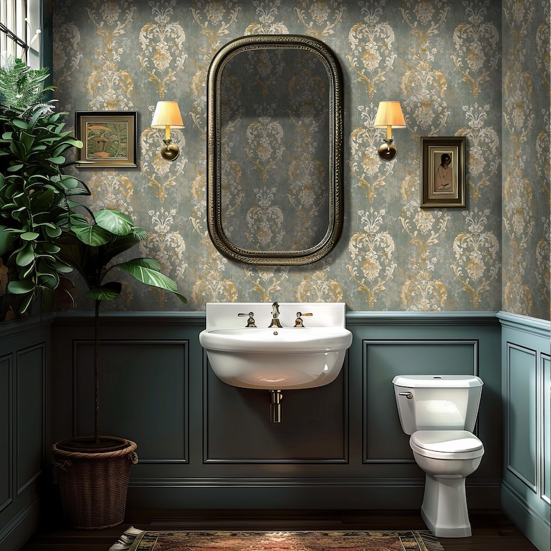 Blue damask wallpaper with a repeating French classic pattern in blue-gray, ivory, muted gold, and taupe, styled in a powder room with painted wainscoting, brass sconces, antique mirror, wall-mounted sink, framed art, and dark wood flooring.