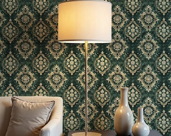 May include: A floor lamp with a cream-colored lampshade and a gold-colored base stands next to a sofa and a table. Two decorative vases sit on the table. The background is a dark green wallpaper with a gold floral pattern.