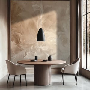 May include: A round wooden dining table with a black pendant light hanging above it. Two white chairs are placed on either side of the table. The wall behind the table features a beige and white abstract swirl pattern.