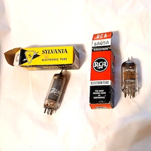 May include: An assortment of vintage electronic tubes, including a Sylvania tube in a yellow box and an RCA tube in a red box. The RCA box reads "6AQ5A Radiotron Electron Tube". The tubes are for electronics.