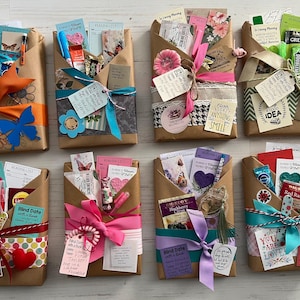May include: Eight brown paper packages, each wrapped with colorful ribbons and bows. The packages contain books and small gifts, with tags that read "Blind Date with a Book" and other phrases. Floral and heart decorations are also visible.