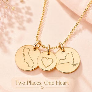 Personalized two state necklace with heart charm shown in gold with custom location discs.