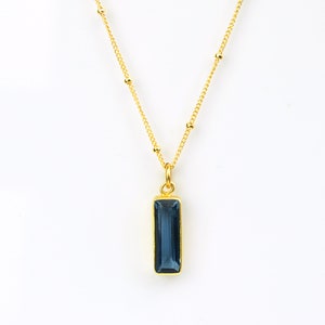 A vertical blue kyanite September birthstone Adira bar necklace on a gold satellite chain. Best friend jewelry, mom necklace, grandmother necklace, gift for aunt, gift for sister, nonbinary, gender neutral gift, Bat Mitzvahs, Sweet Sixteen parties