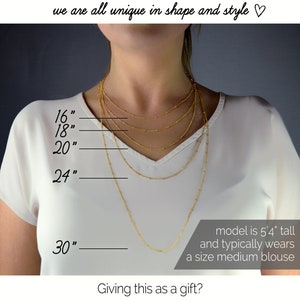 A woman with light skin and a white v-neck t shirt. She is wearing 5 satellite style necklace chains at varying lengths. Cable chains available. Gold chains. Silver chains. Layering necklaces, beaded necklaces, simple chain, minimalist chain, new mom