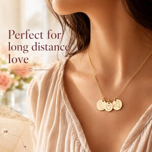 Long-distance love necklace worn by model with custom state charms and heart pendant.