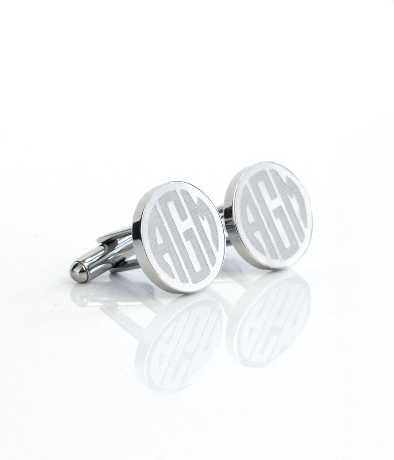 Round Silver stainless steel cufflinks with A G M engraved in a Spherical Monogram on a white surface. Dad gift, bar mitzvah gift, award ceremony gift, promotion at work, congratulations, new business launch, new job, black tie wedding, Best Man Gift