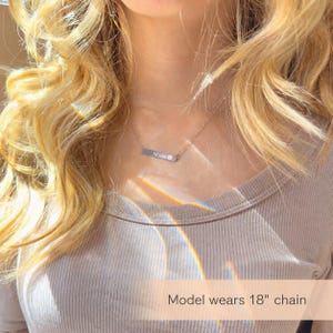Model wearing custom pet name bar necklace on 18 inch chain, showing dainty everyday fit and necklace length.