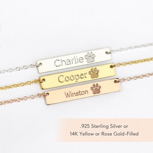 Paw print bar necklaces shown in sterling silver, yellow gold filled, and rose gold filled with custom pet name engraving.