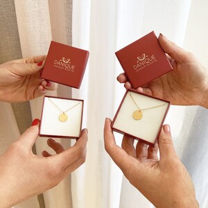 Custom long distance necklace shown in Danique Jewelry gift boxes.