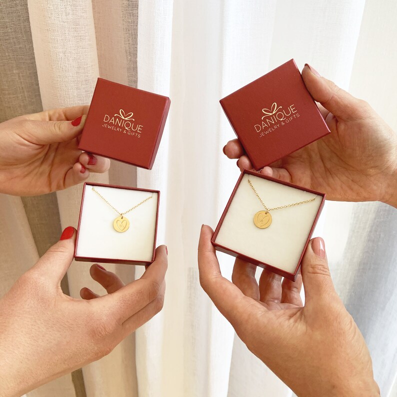 Custom long distance necklace shown in Danique Jewelry gift boxes.