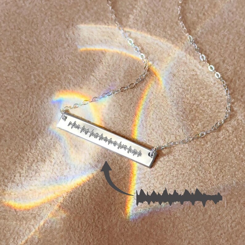 Personalized silver heartbeat bar necklace engraved with baby’s actual heartbeat image, displayed with rainbow light. Unique keepsake jewelry gift for moms, new mothers, or memorial necklace. Perfect for push present, baby shower, or pregnancy announcement.