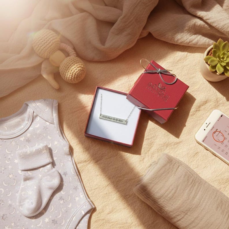 Flat-lay gift set with heartbeat necklace in box; personalized sound wave bar engraved from sonogram or voice; newborn announcement jewelry, baby shower favor, gender reveal gift; 14k gold filled/sterling/rose gold options, ready-to-gift packaging.
