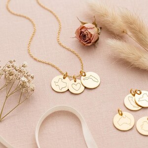 Personalized necklace with custom city, state, country, or coordinate engraving examples.