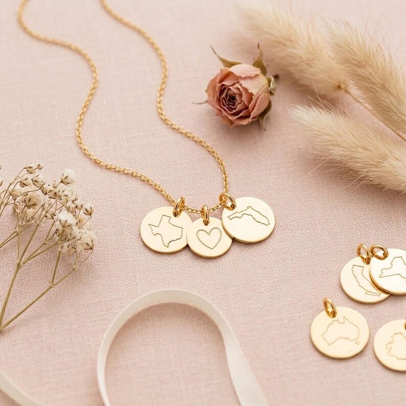 Personalized necklace with custom city, state, country, or coordinate engraving examples.