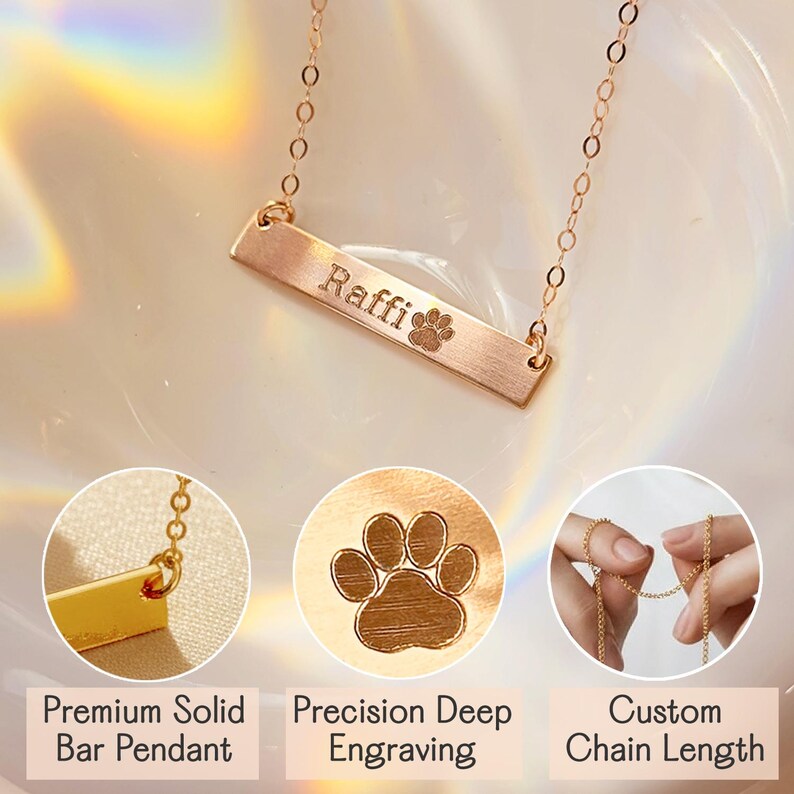 Close-up of gold bar necklace engraved with name ‘Raffi’ and paw print, shown with details highlighting premium solid bar pendant, precision deep engraving, and custom chain length. Personalized pet name jewelry by Danique Jewelry. Custom engraved dog or cat necklace made from 925 sterling silver, 14K gold, or rose gold filled. High-quality handmade memorial keepsake gift for pet owners, featuring durable engraving and minimalist design.