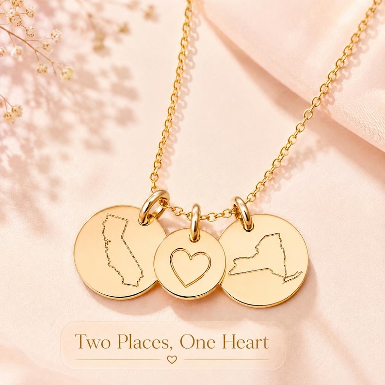 Personalized two state necklace with heart charm shown in gold with custom location discs.