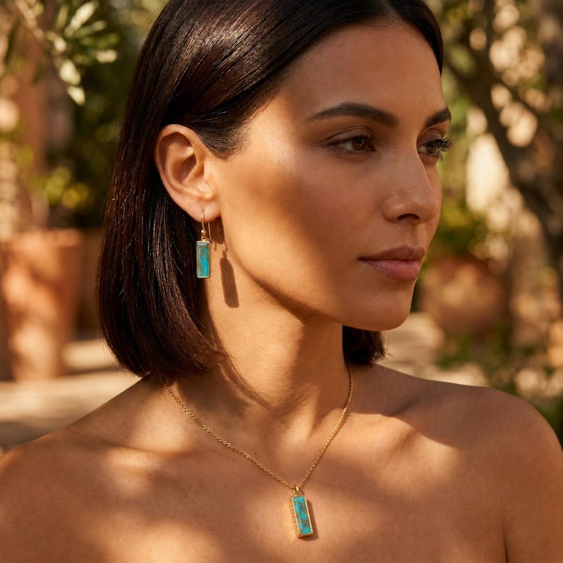 Turquoise December birthstone necklace and earrings styled on a model in warm natural light for everyday wear.