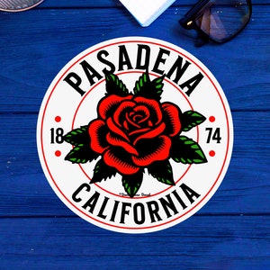May include: White circle sticker with red and green rose graphic and the text "PASADENA CALIFORNIA 1874".