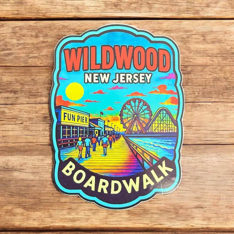 May include: A colorful Wildwood New Jersey Boardwalk sticker. The sticker features a boardwalk scene with a Ferris wheel, roller coaster, and people walking. The text "Wildwood New Jersey Boardwalk" is displayed in red and white.
