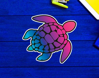 May include: A colorful sticker featuring a sea turtle design. The turtle's shell transitions from blue to purple to pink, outlined in black. The sticker has a white border and is placed on a blue wooden surface.