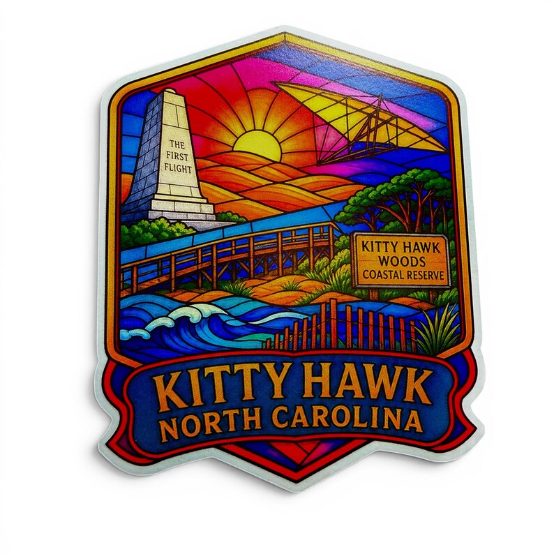 May include: A colorful sticker featuring a stained-glass style illustration of Kitty Hawk, North Carolina. It depicts the Wright Brothers monument, a hang glider, a wooden boardwalk, and the text "THE FIRST FLIGHT," "KITTY HAWK WOODS COASTAL RESERVE," and "KITTY HAWK NORTH CAROLINA."