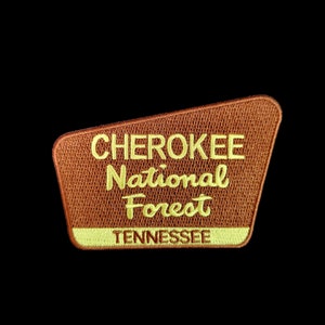 May include: A brown patch with yellow embroidered text that reads "CHEROKEE National Forest TENNESSEE".