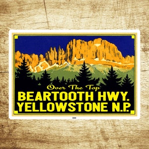 May include: A vintage travel poster featuring a yellow and orange mountain range against a blue sky. The text reads "Over The Top Beartooth Hwy. Yellowstone N.P."