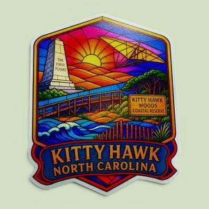 May include: A colorful sticker featuring a stained-glass style illustration of Kitty Hawk, North Carolina. It depicts the Wright Brothers monument with the text The First Flight, a glider, a wooden boardwalk, and a sign reading Kitty Hawk Woods Coastal Reserve.
